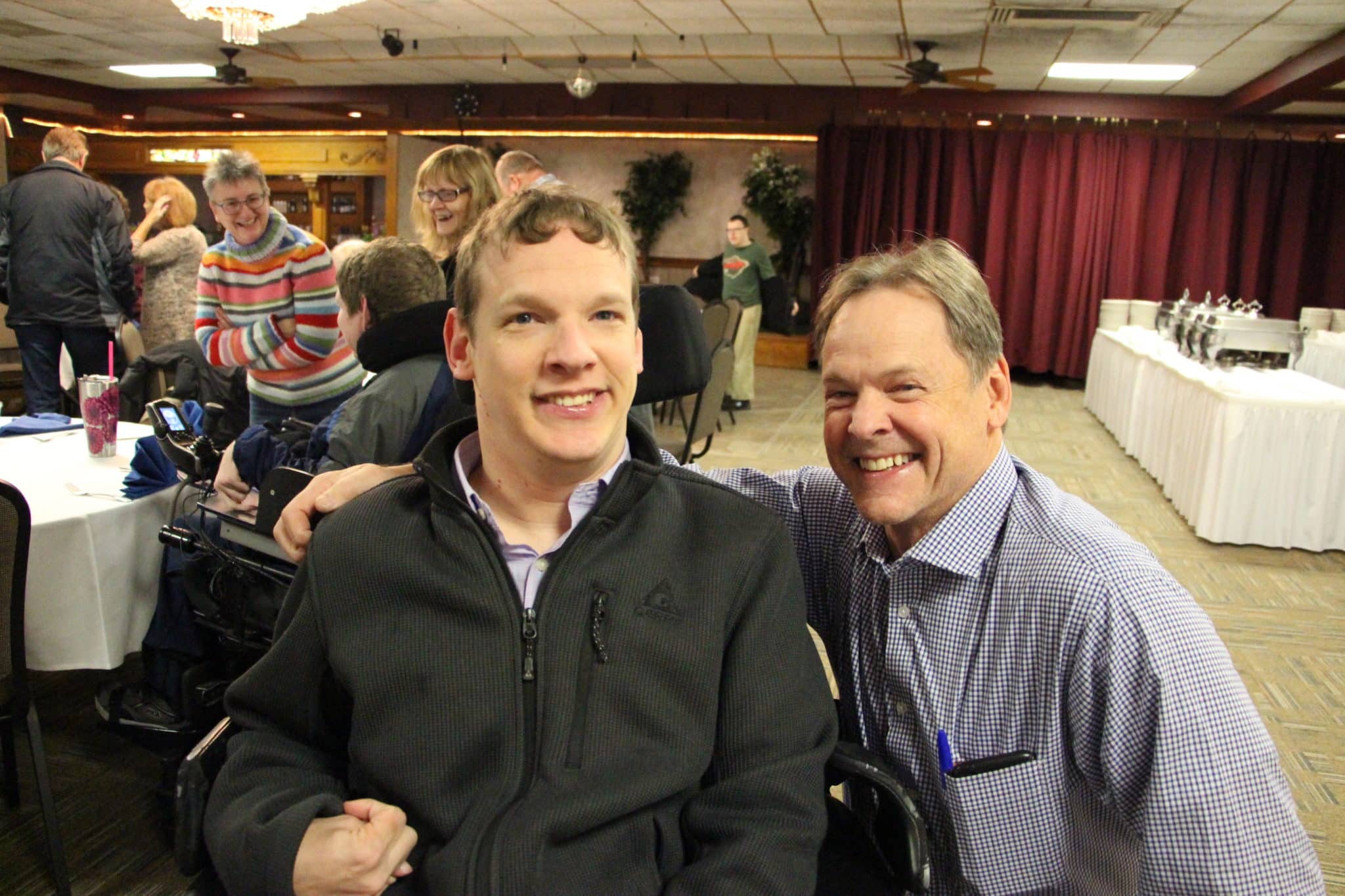 Jameson and Tom pose together at Achieve's Fall Fundraiser